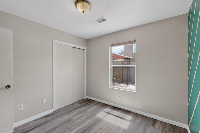 10639 Miera Dr NW, Albuquerque, NM 87114 - unfurnished bedroom with wood finished floors and a closet