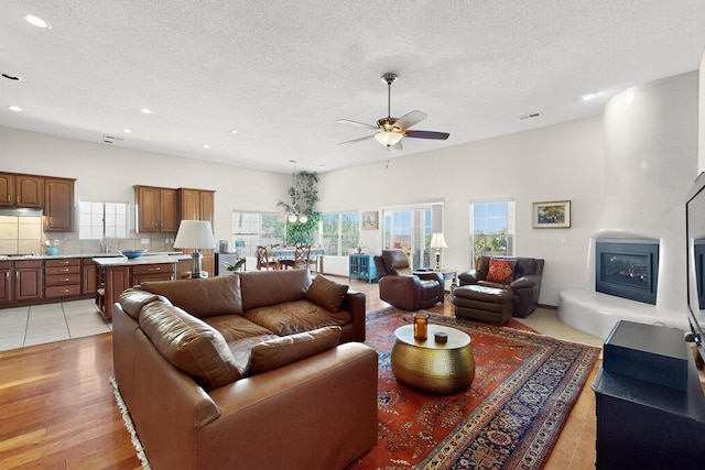8712 Sandwater Rd NW, Albuquerque, NM 87120 - living area with a ceiling fan, healthy amount of natural light, a textured ceiling, recessed lighting, and light wood-type flooring