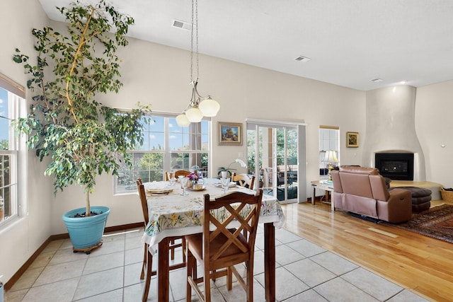 8712 Sandwater Rd NW, Albuquerque, NM 87120 - dining area with light tile patterned floors and a large fireplace