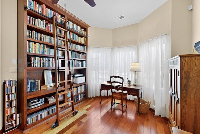 8712 Sandwater Rd NW, Albuquerque, NM 87120 - office space featuring bookshelves, hardwood / wood-style flooring, and a ceiling fan