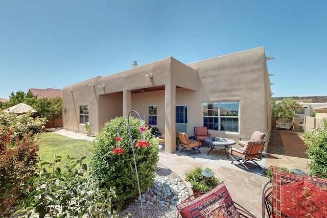 8712 Sandwater Rd NW, Albuquerque, NM 87120 - rear view of property with a patio area, a gate, stucco siding, and a fire pit