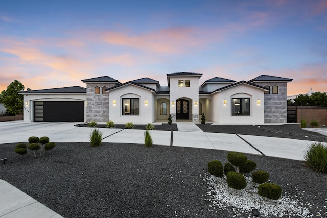 7900 Aguila St NW, Albuquerque, NM 87120 - french provincial home with a garage, driveway, stucco siding, stone siding, and french doors