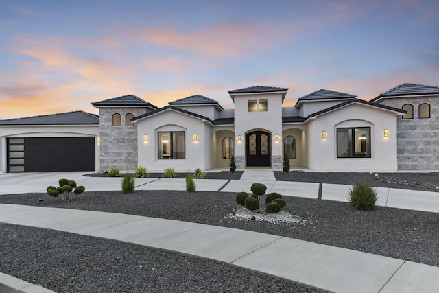 7900 Aguila St NW, Albuquerque, NM 87120 - view of front of property featuring a garage, concrete driveway, stucco siding, french doors, and a tiled roof