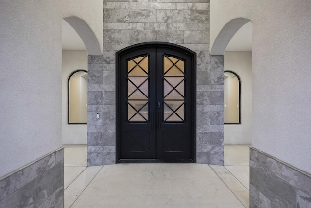 7900 Aguila St NW, Albuquerque, NM 87120 - entrance to property with french doors, stucco siding, and stone siding