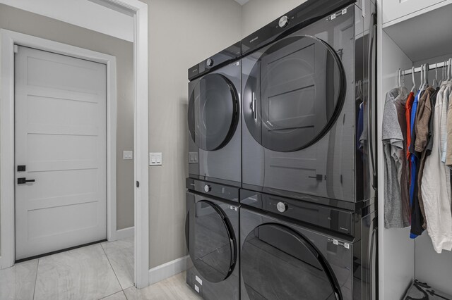 7900 Aguila St NW, Albuquerque, NM 87120 - laundry room featuring cabinet space, light tile patterned flooring, and estacked washer and dryer