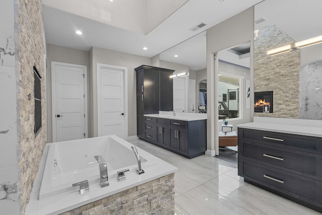 7900 Aguila St NW, Albuquerque, NM 87120 - full bathroom featuring vanity, a tub with jets, a large fireplace, and recessed lighting