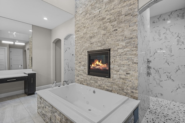 7900 Aguila St NW, Albuquerque, NM 87120 - bathroom featuring a whirlpool tub, a tile shower, vanity, marble finish flooring, and a glass covered fireplace