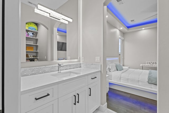 7900 Aguila St NW, Albuquerque, NM 87120 - ensuite bathroom featuring vanity and wood finished floors