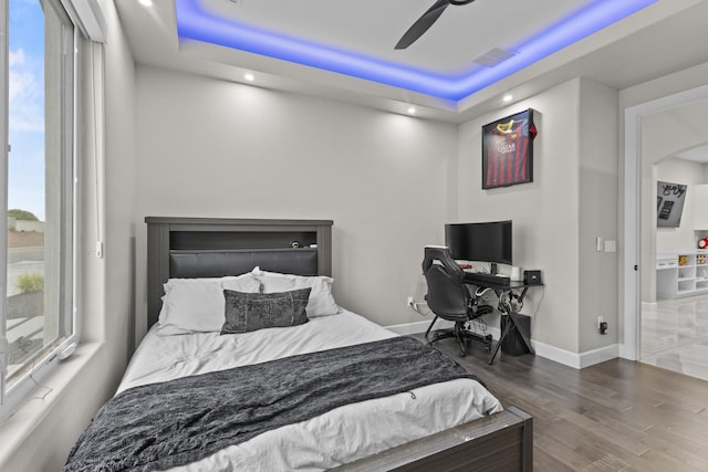 7900 Aguila St NW, Albuquerque, NM 87120 - bedroom with a raised ceiling, wood finished floors, arched walkways, a ceiling fan, and recessed lighting