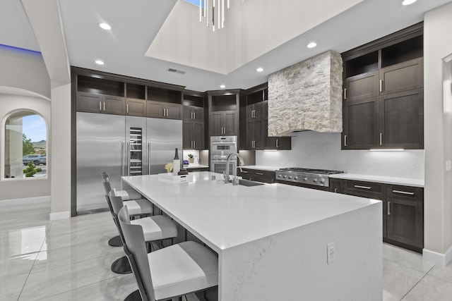 7900 Aguila St NW, Albuquerque, NM 87120 - kitchen with open shelves, appliances with stainless steel finishes, recessed lighting, light tile patterned floors, and a spacious island