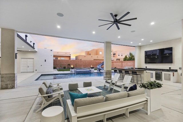 7900 Aguila St NW, Albuquerque, NM 87120 - fenced backyard with an outdoor hangout area, an outdoor kitchen, a pool with connected hot tub, a patio, and a ceiling fan