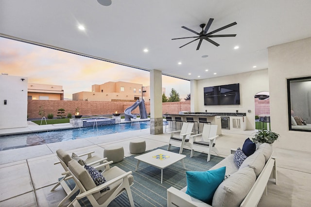 7900 Aguila St NW, Albuquerque, NM 87120 - fenced backyard with an outdoor living space, an outdoor kitchen, a ceiling fan, a pool with connected hot tub, and a patio