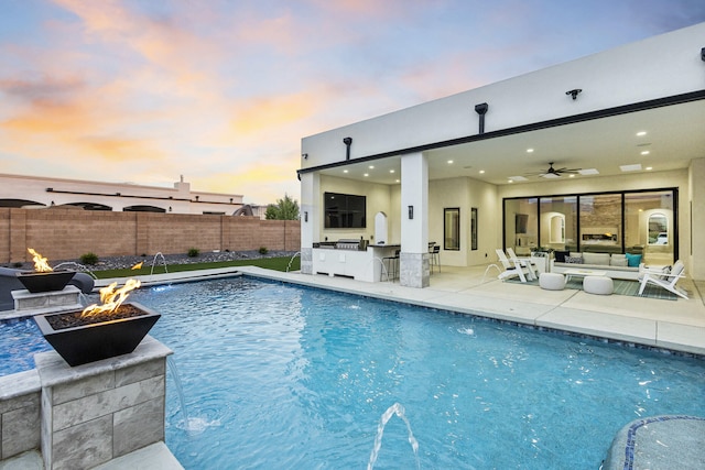 7900 Aguila St NW, Albuquerque, NM 87120 - view of pool with an outdoor kitchen, a patio, ceiling fan, and an outdoor living space with a fire pit