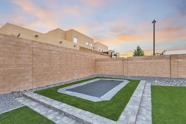 7900 Aguila St NW, Albuquerque, NM 87120 - yard at dusk with a fenced backyard