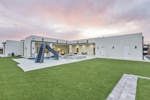 7900 Aguila St NW, Albuquerque, NM 87120 - back of property featuring a patio area, a lawn, and stucco siding