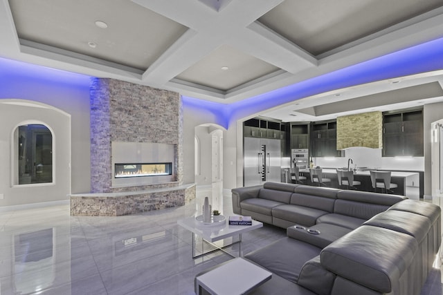 7900 Aguila St NW, Albuquerque, NM 87120 - living room featuring coffered ceiling, an outdoor stone fireplace, and beam ceiling