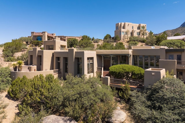 213 Spring Creek Pl NE, Albuquerque, NM 87122 - rear view of house featuring stucco siding and a mountain view
