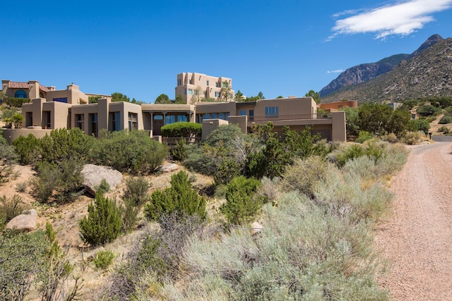 213 Spring Creek Pl NE, Albuquerque, NM 87122 - view of front facade with stucco siding and a mountain view
