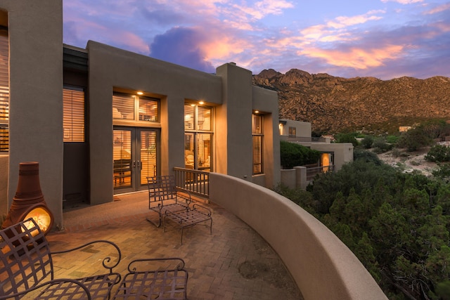 213 Spring Creek Pl NE, Albuquerque, NM 87122 - patio terrace at dusk featuring french doors and a mountain view