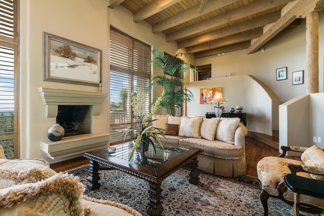 213 Spring Creek Pl NE, Albuquerque, NM 87122 - living room with a wood ceiling with exposed beams, wood finished floors, a fireplace with raised hearth, and arched walkways