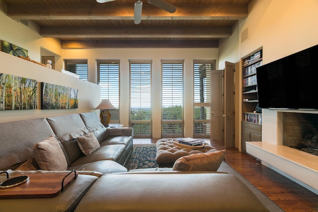 213 Spring Creek Pl NE, Albuquerque, NM 87122 - living area with a wood ceiling with exposed beams, a ceiling fan, dark wood finished floors, and a fireplace with raised hearth