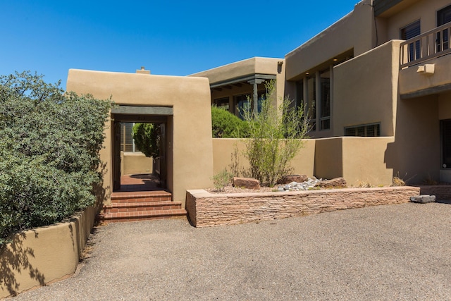 213 Spring Creek Pl NE, Albuquerque, NM 87122 - property entrance featuring stucco siding and a chimney