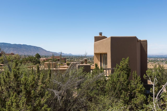 213 Spring Creek Pl NE, Albuquerque, NM 87122 - view of side of home with a mountain view and stucco siding