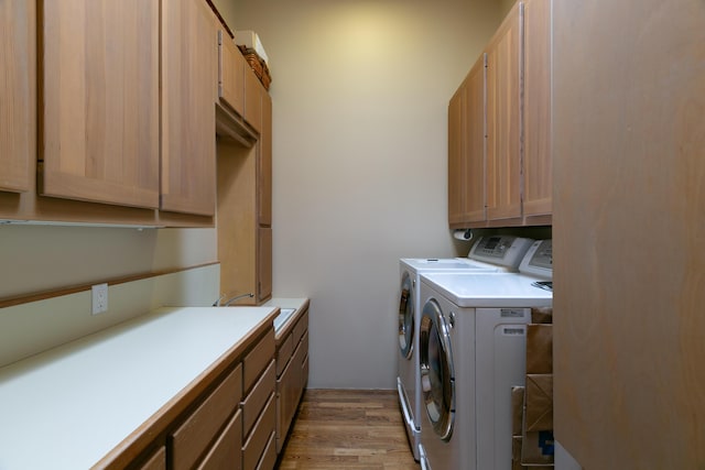 213 Spring Creek Pl NE, Albuquerque, NM 87122 - laundry area featuring light wood-type flooring, separate washer and dryer, and cabinet space
