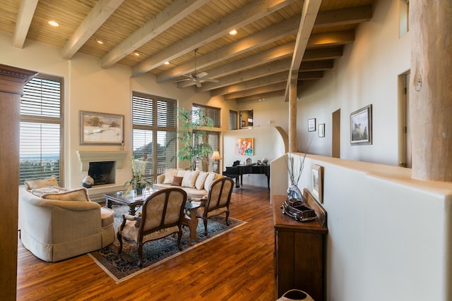 213 Spring Creek Pl NE, Albuquerque, NM 87122 - living room with a wooden ceiling with exposed beams, a fireplace with raised hearth, a ceiling fan, dark wood-style flooring, and healthy amount of natural light