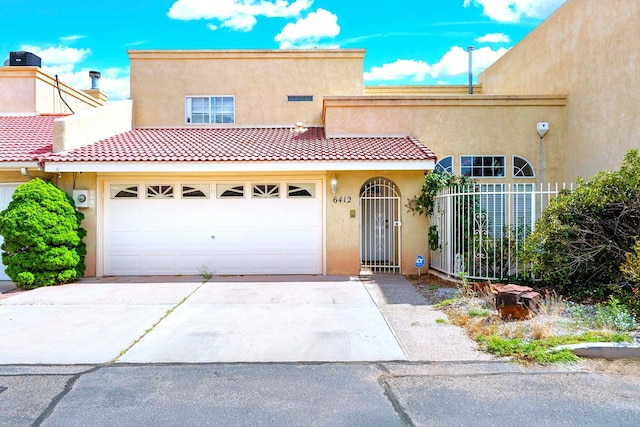 6412 Saint Josephs Ave NW, Albuquerque, NM 87120 - view of front facade with stucco siding, concrete driveway, a tiled roof, and a garage