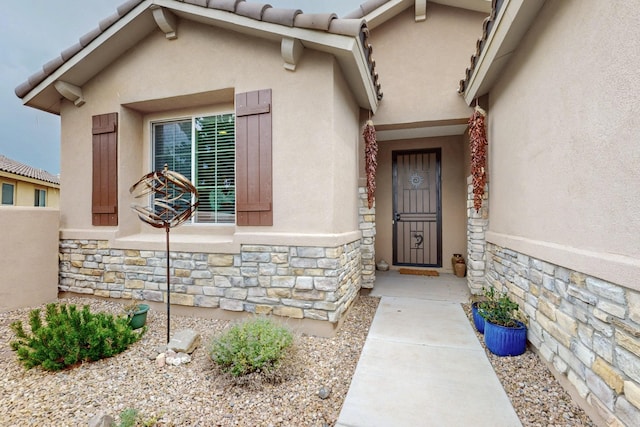 6417 Kings Cyn NE, Rio Rancho, NM 87144 - doorway to property with stone siding and stucco siding