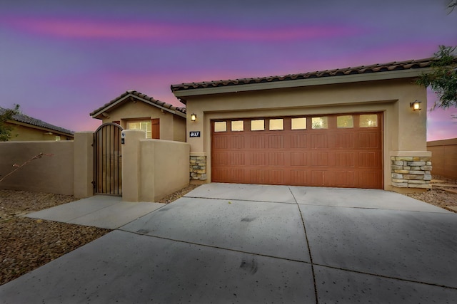 6417 Kings Cyn NE, Rio Rancho, NM 87144 - view of front facade with stucco siding, stone siding, and a gate