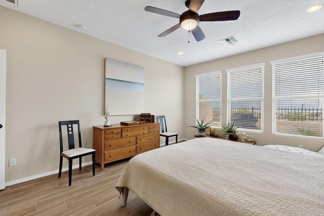6417 Kings Cyn NE, Rio Rancho, NM 87144 - bedroom with wood tiled floors, recessed lighting, a textured ceiling, and ceiling fan