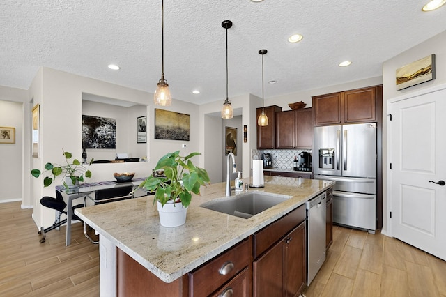 6417 Kings Cyn NE, Rio Rancho, NM 87144 - kitchen featuring stainless steel appliances, light wood finished floors, tasteful backsplash, pendant lighting, and recessed lighting