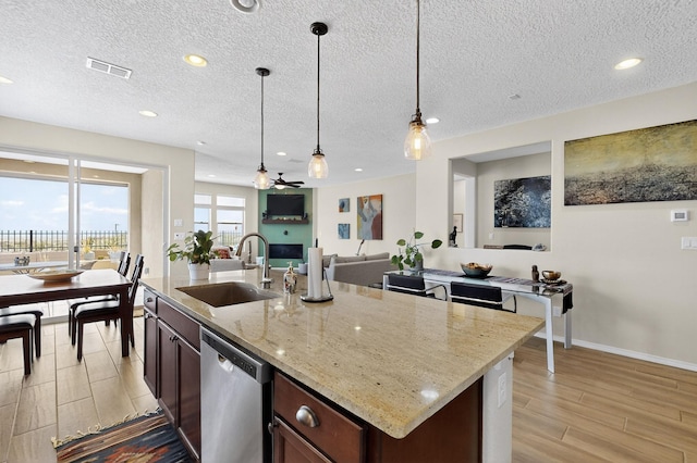 6417 Kings Cyn NE, Rio Rancho, NM 87144 - kitchen featuring stainless steel dishwasher, light wood-style floors, hanging light fixtures, recessed lighting, and light stone counters