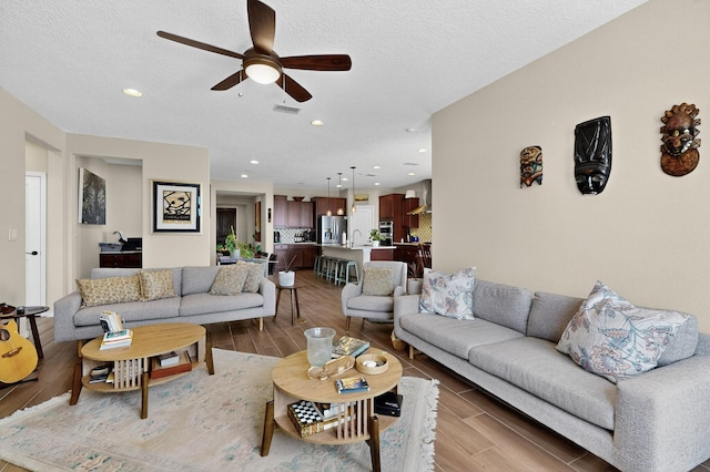 6417 Kings Cyn NE, Rio Rancho, NM 87144 - living area featuring ceiling fan, wood finished floors, recessed lighting, and a textured ceiling