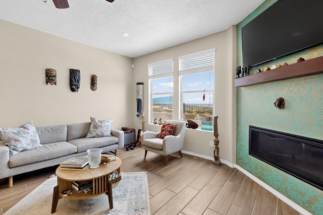 6417 Kings Cyn NE, Rio Rancho, NM 87144 - living room with wood tiled floors, a textured ceiling, and ceiling fan