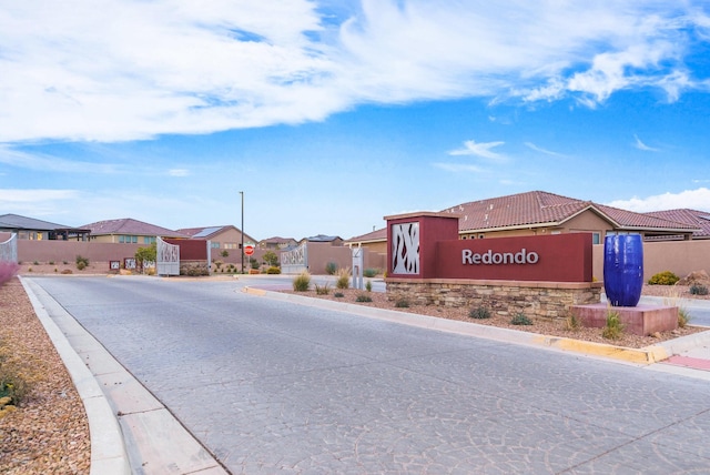 6417 Kings Cyn NE, Rio Rancho, NM 87144 - view of asphalt road featuring curbs, a residential view, and traffic signs