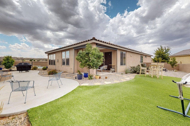 6417 Kings Cyn NE, Rio Rancho, NM 87144 - rear view of property with a fenced backyard, a patio area, stucco siding, and a tile roof