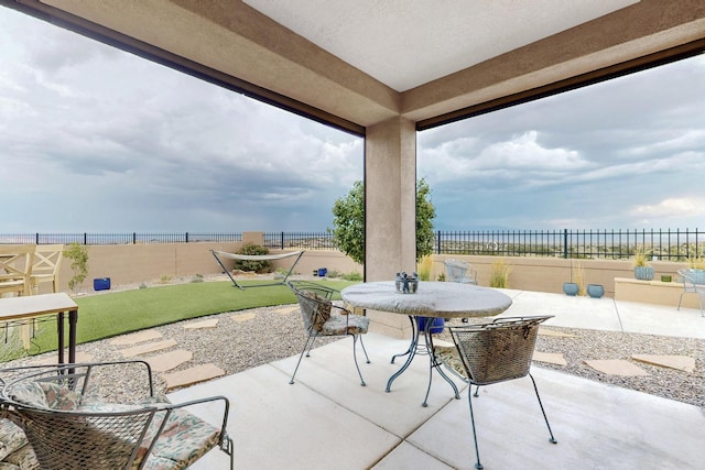 6417 Kings Cyn NE, Rio Rancho, NM 87144 - fenced backyard with a patio area and outdoor dining space