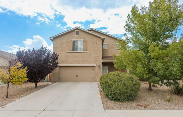 148 El Camino Loop NW, Rio Rancho, NM 87144 - view of front facade with stucco siding, driveway, and a garage