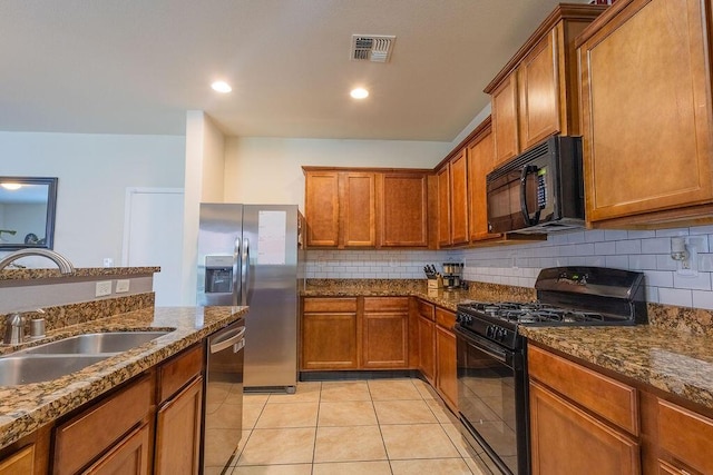148 El Camino Loop NW, Rio Rancho, NM 87144 - kitchen with black appliances, brown cabinetry, tasteful backsplash, light tile patterned floors, and recessed lighting