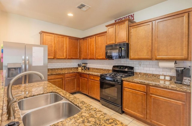 148 El Camino Loop NW, Rio Rancho, NM 87144 - kitchen featuring black appliances, light stone countertops, and backsplash