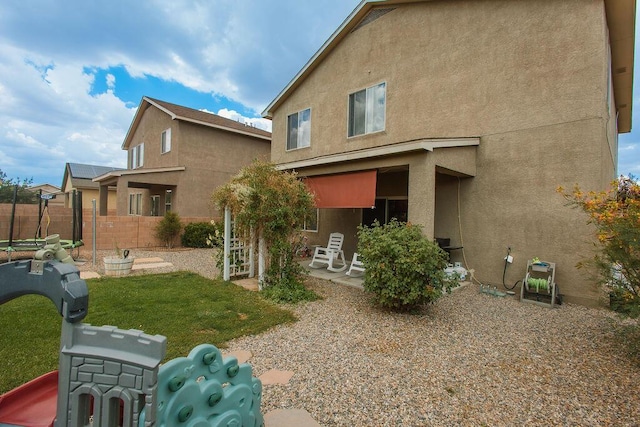 148 El Camino Loop NW, Rio Rancho, NM 87144 - rear view of property with stucco siding and a patio area