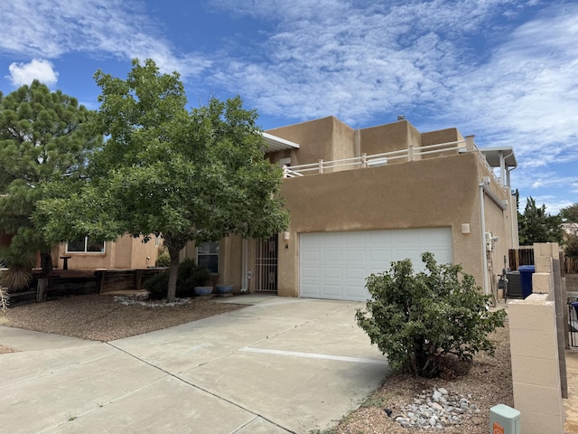 5400 Pegasus Dr NW, Albuquerque, NM 87120 - adobe home with stucco siding, concrete driveway, and a garage