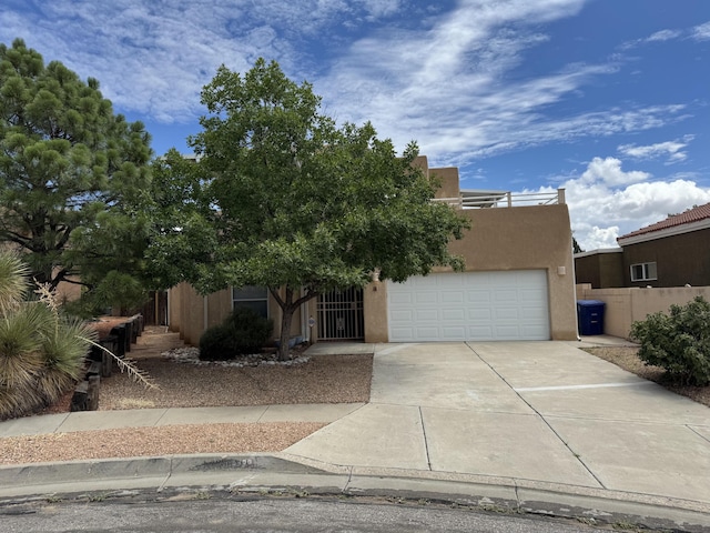 5400 Pegasus Dr NW, Albuquerque, NM 87120 - view of front of house with driveway, stucco siding, and an attached garage