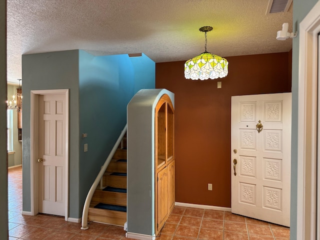 5400 Pegasus Dr NW, Albuquerque, NM 87120 - stairs with a textured ceiling, tile patterned floors, and a chandelier