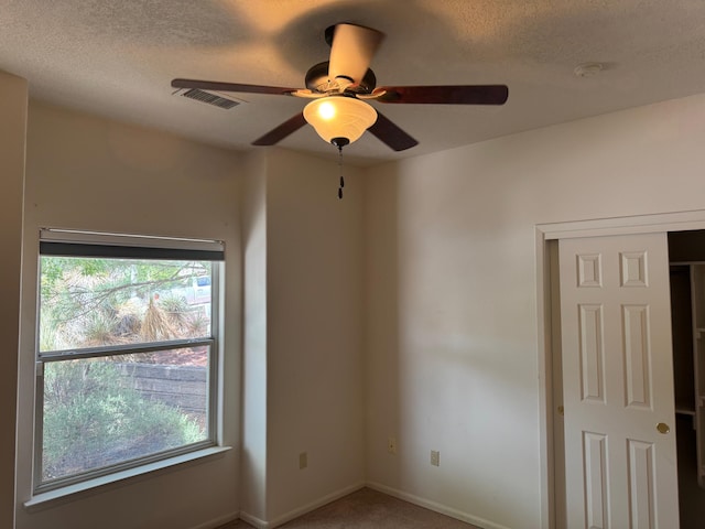 5400 Pegasus Dr NW, Albuquerque, NM 87120 - carpeted spare room featuring healthy amount of natural light, ceiling fan, and a textured ceiling