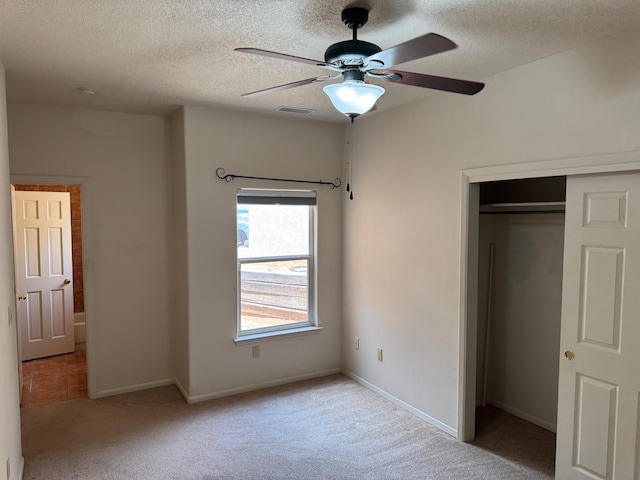 5400 Pegasus Dr NW, Albuquerque, NM 87120 - unfurnished bedroom featuring a textured ceiling, carpet, a closet, and ceiling fan
