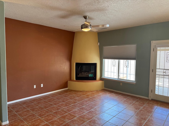 5400 Pegasus Dr NW, Albuquerque, NM 87120 - unfurnished living room featuring healthy amount of natural light, a ceiling fan, tile patterned floors, and a textured ceiling